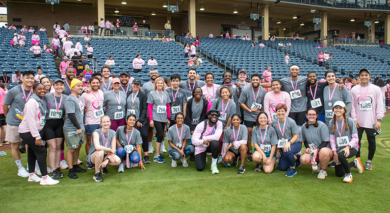 More than 90 PCOM Georgia community members volunteered Large group of PCOM Georgia students, faculty, and staff smiling in pink attire